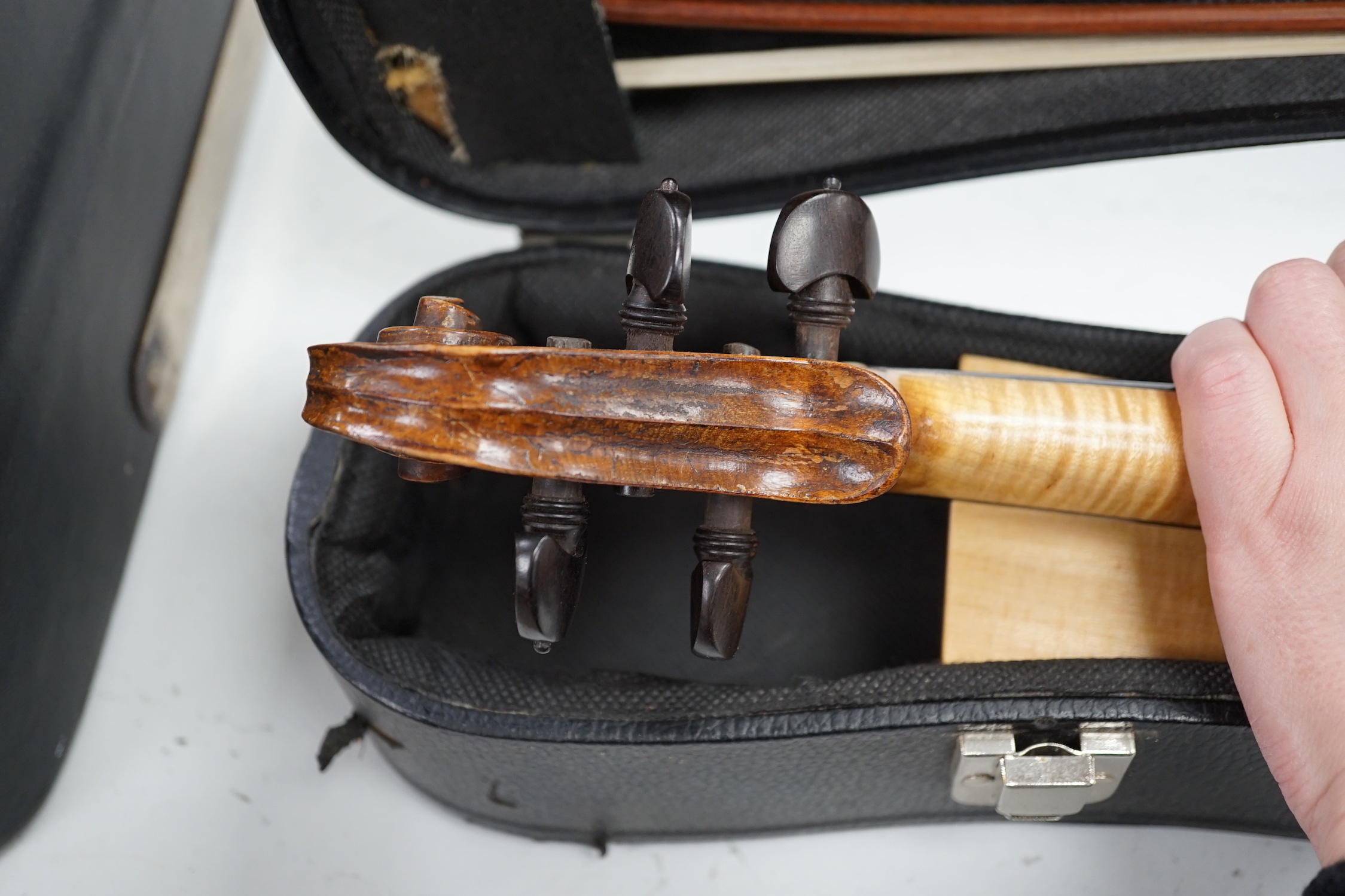 An unusual travelling violin (Pochette), length of body, 25.5cm, with standard length neck, with shorter 53.5cm bow and fitted case, overall length of violin 55cm